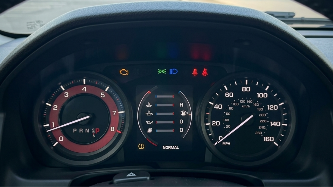 GM Dashboard TPMS Warning Light Illuminated Car dashboard showing an amber tire pressure monitoring system warning light, indicating low pressure or sensor failure